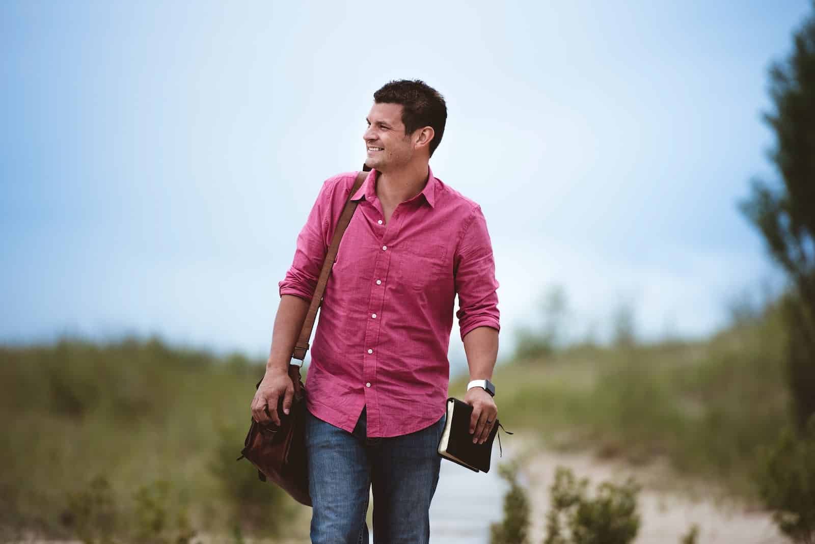 Christian community - man carrying bag walking on street
